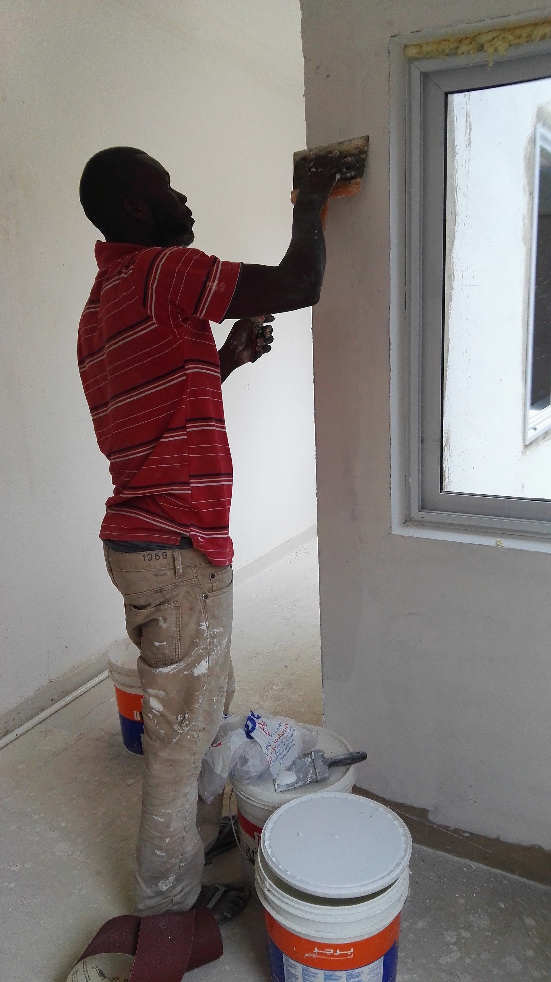Painter applying paint on a wall